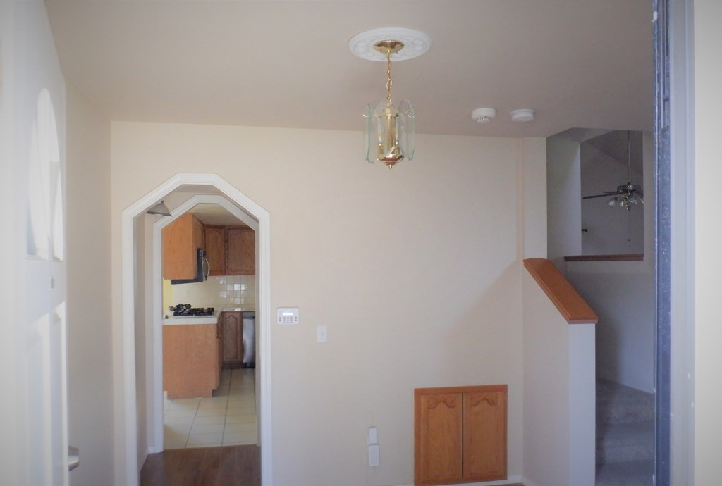 a view of the hallway from the living room into the kitchen