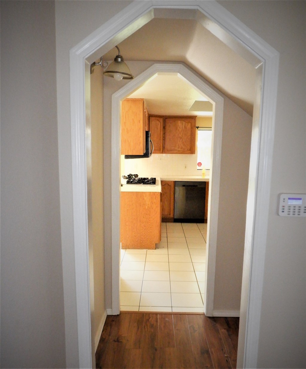 a view of a kitchen from the hallway of a house
