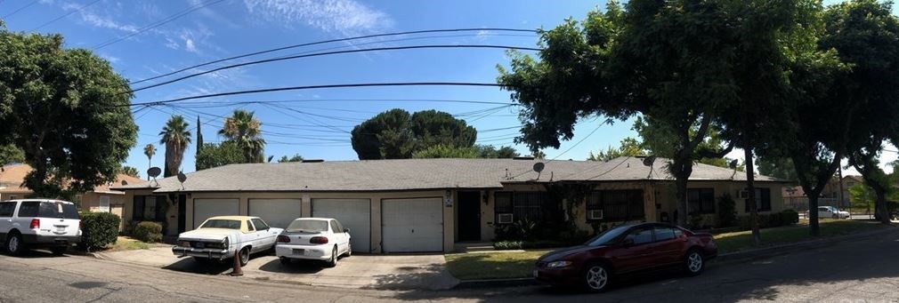 a house with three cars parked in front of it
