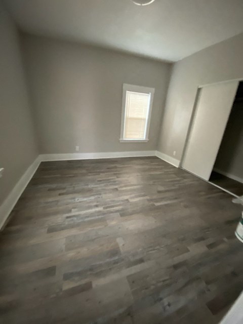 the living room of a house with wooden floors