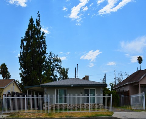 a house with a white fence in front of it