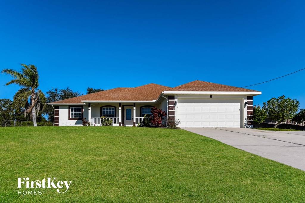 a home with a lawn and a garage