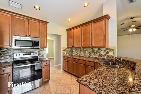 kitchen with granite counter tops and stainless steel appliances and wooden cabinets