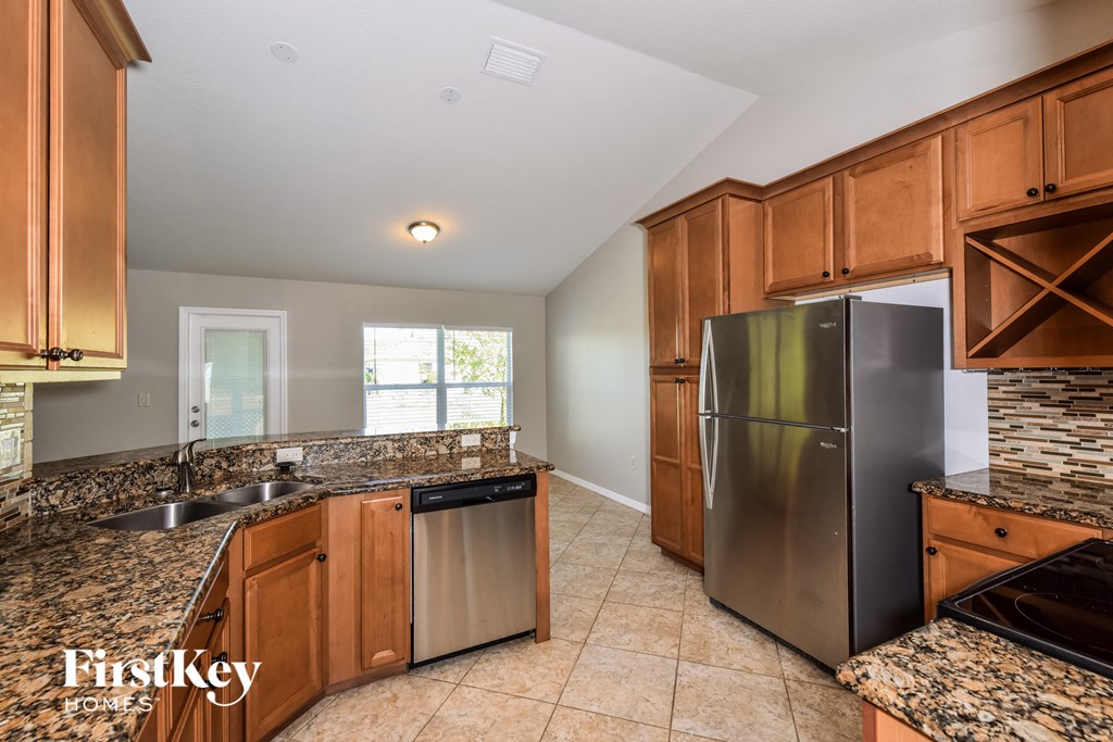 kitchen with stainless steel appliances and granite counter tops and wood cabinets
