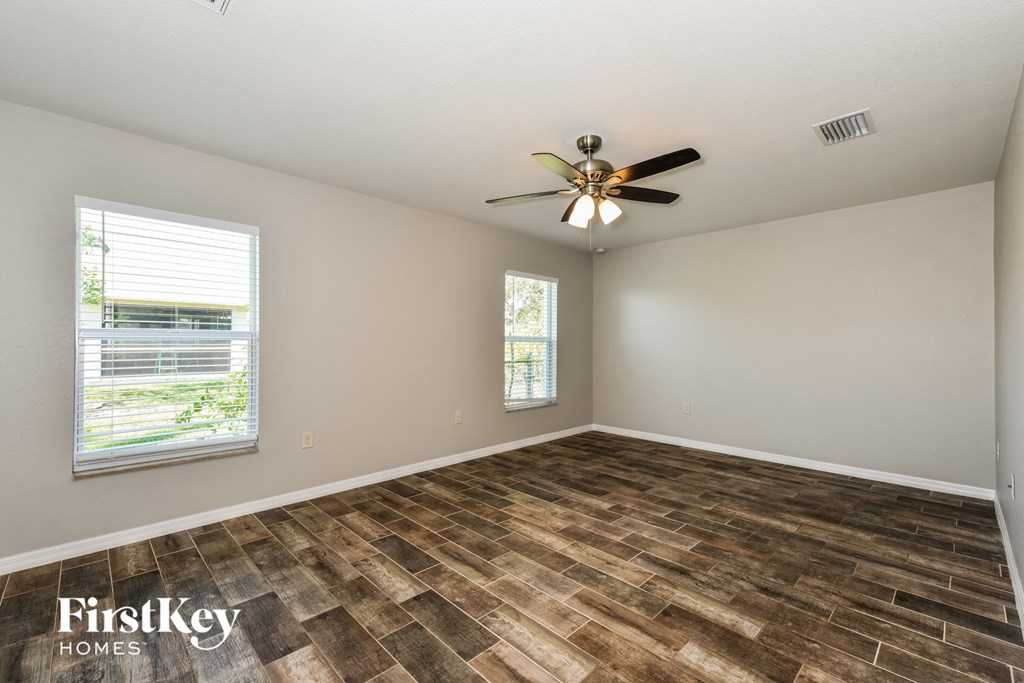 a living room with a ceiling fan and a window