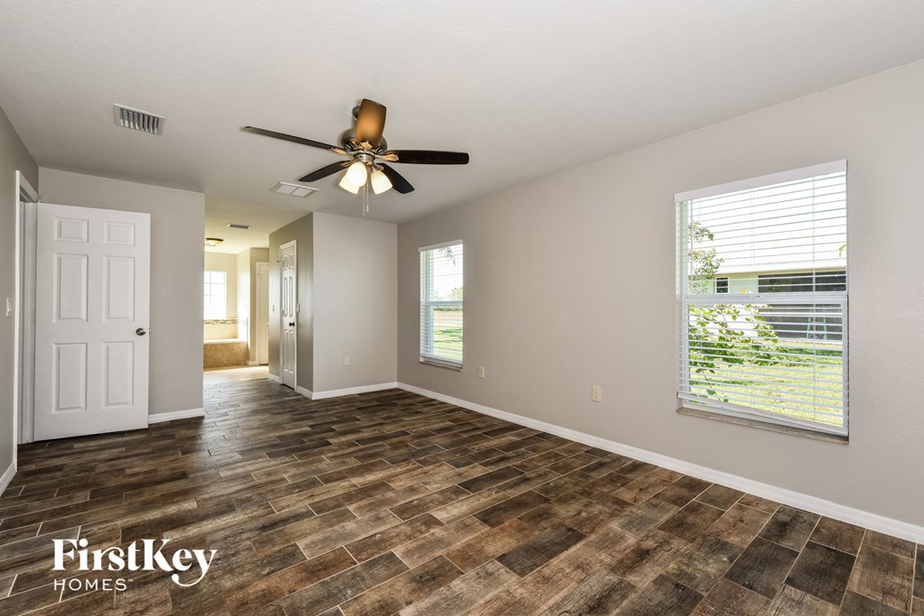 a living room with a ceiling fan and a window