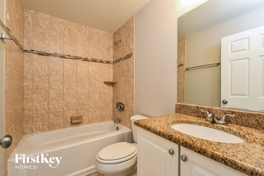 a bathroom with a sink toilet and a bath tub