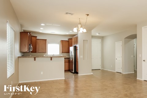 A kitchen area with wooden cabinets and a countertop.