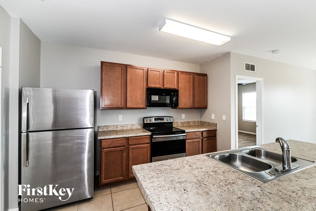 a kitchen with stainless steel appliances and granite counter tops