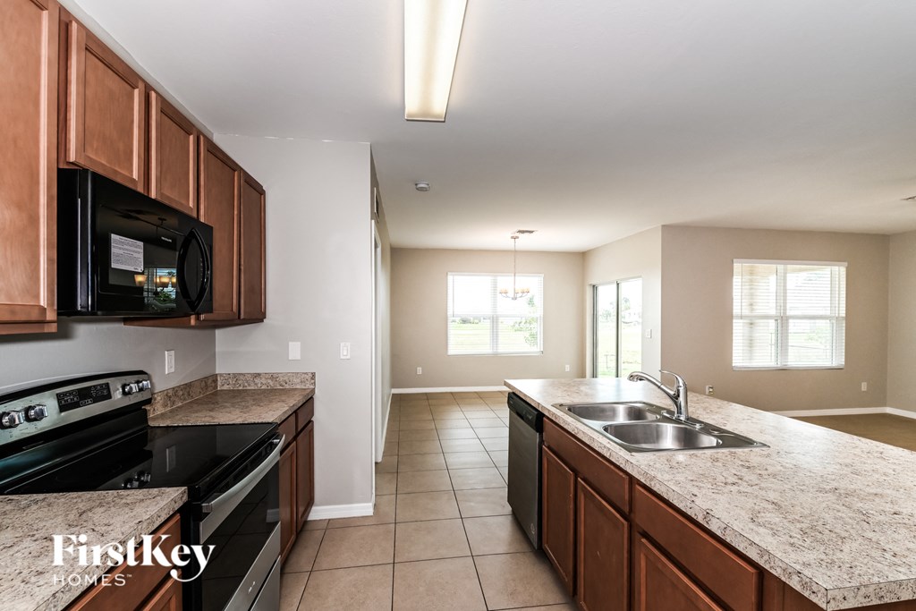 a kitchen with black appliances and granite counter tops