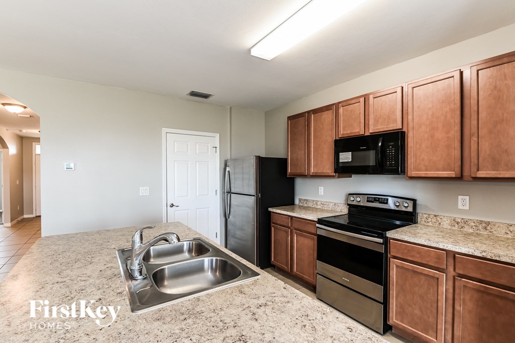 a kitchen with stainless steel appliances and granite counter tops