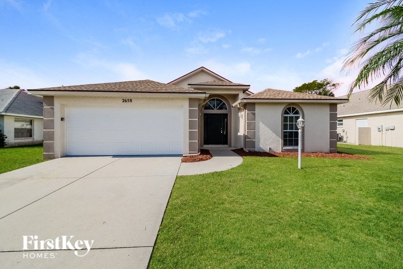 A house with a garage and a driveway is for sale.