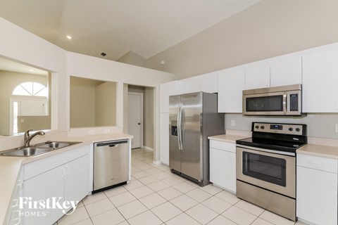 A kitchen with white cabinets and stainless steel appliances.