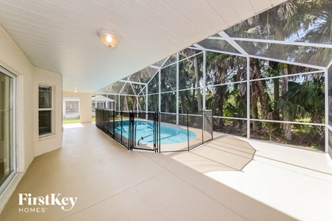 A pool in a house with FirstKey Homes written on the bottom left.