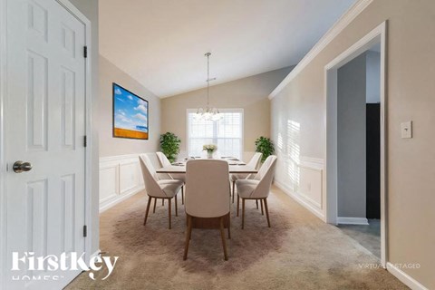 A dining room with a table set for six.