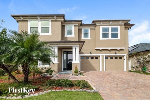 A house with a palm tree in front of it.