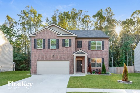 a brick house with the sun shining through the windows