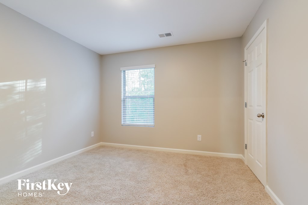 a empty room with a door and a window