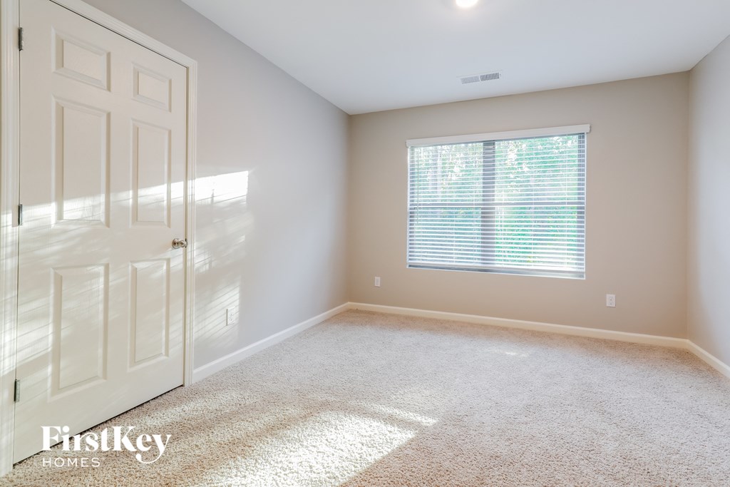 a bedroom with a white door and a window