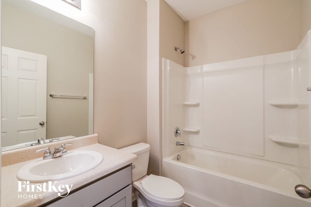 a bathroom with a sink toilet and a bath tub