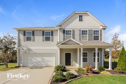 a white house with white siding and a white garage door