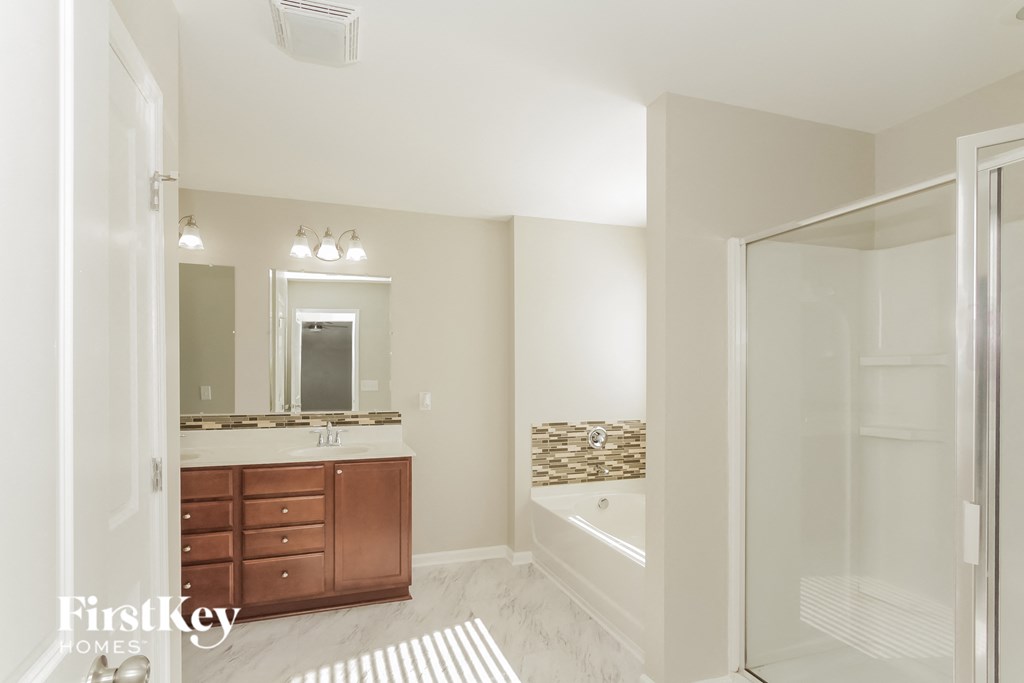 a bathroom with a shower and a sink and a mirror