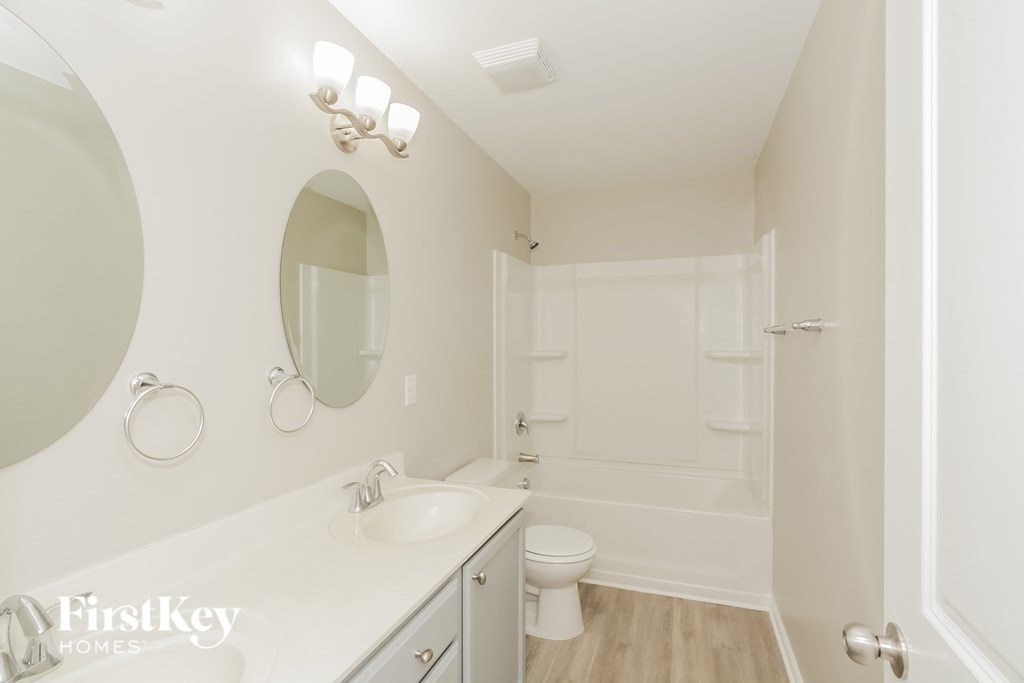 a bathroom with a sink and a toilet and a bath tub