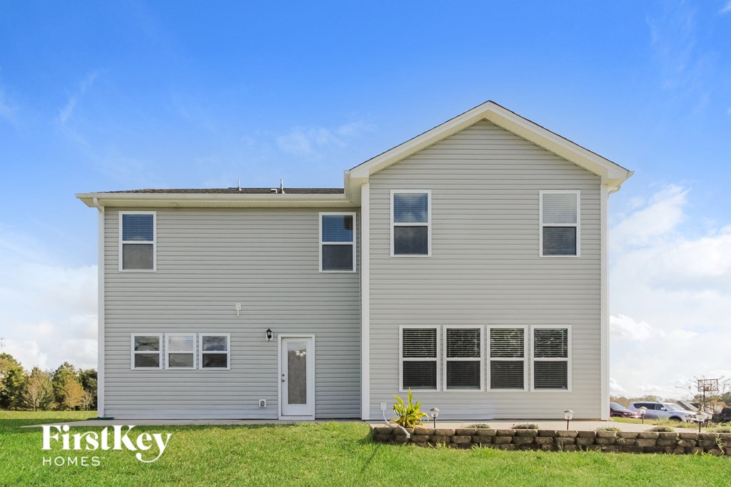 a gray house with a blue sky in the background
