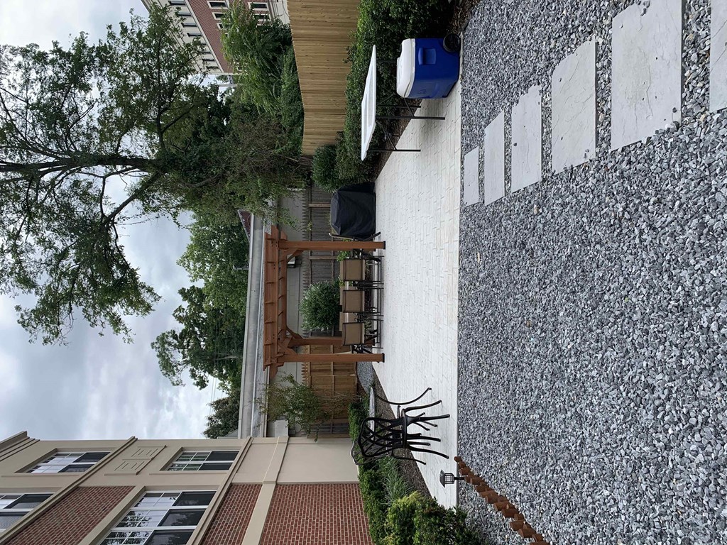 the side of a building with a balcony and a tree