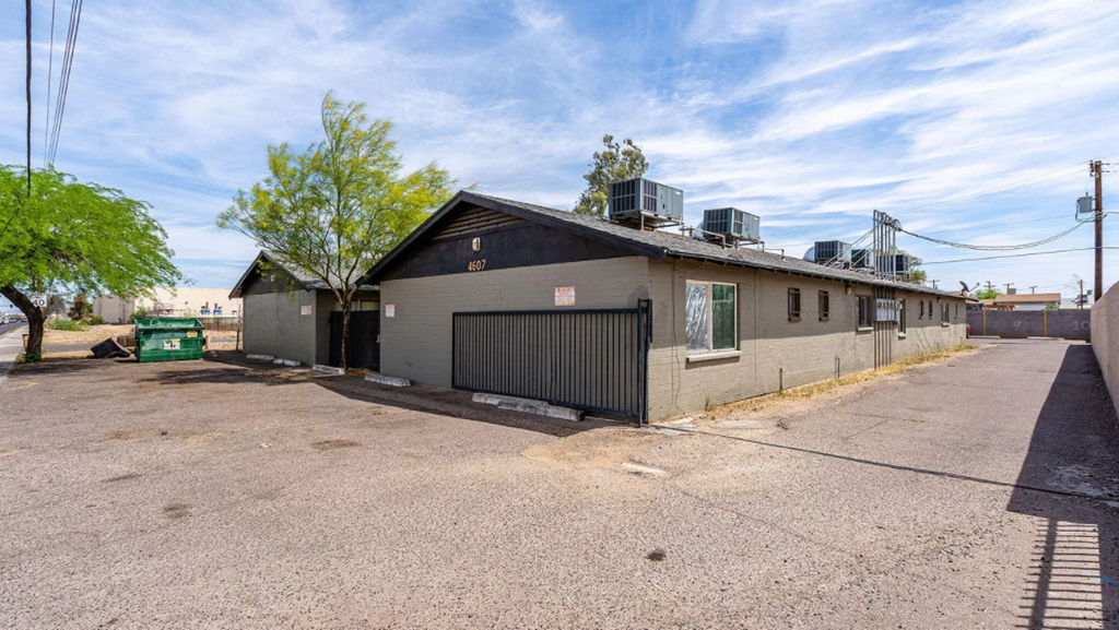 a white and black building with a black garage door