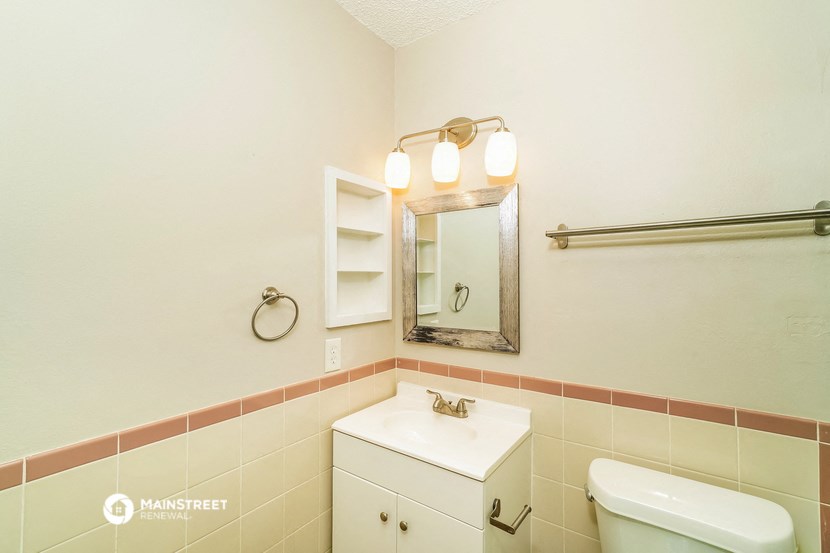 a bathroom with a sink and a mirror and a toilet