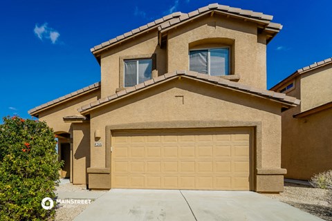 a house with a garage door in front of it