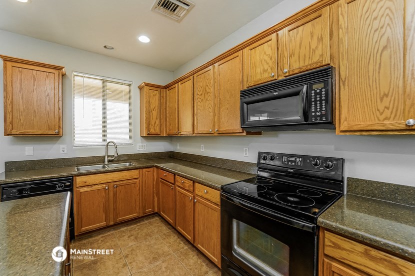 a kitchen with black appliances and wooden cabinets