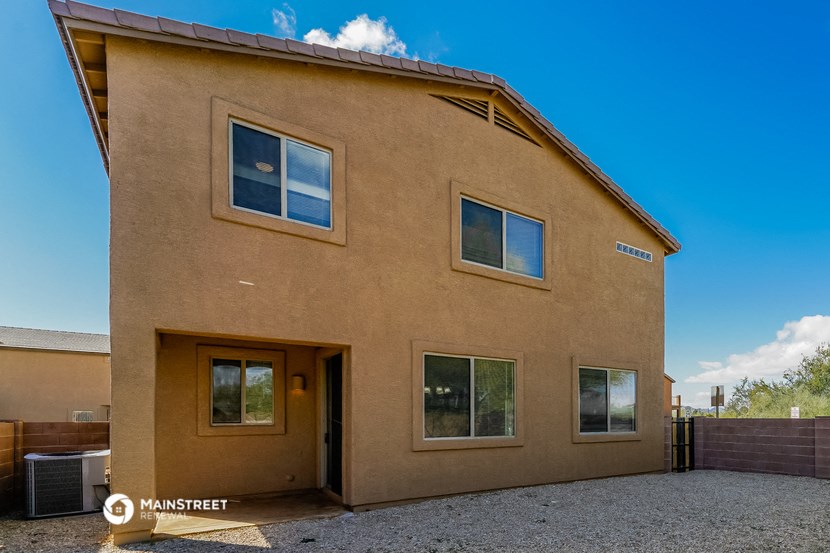 a brown building with a blue sky in the background