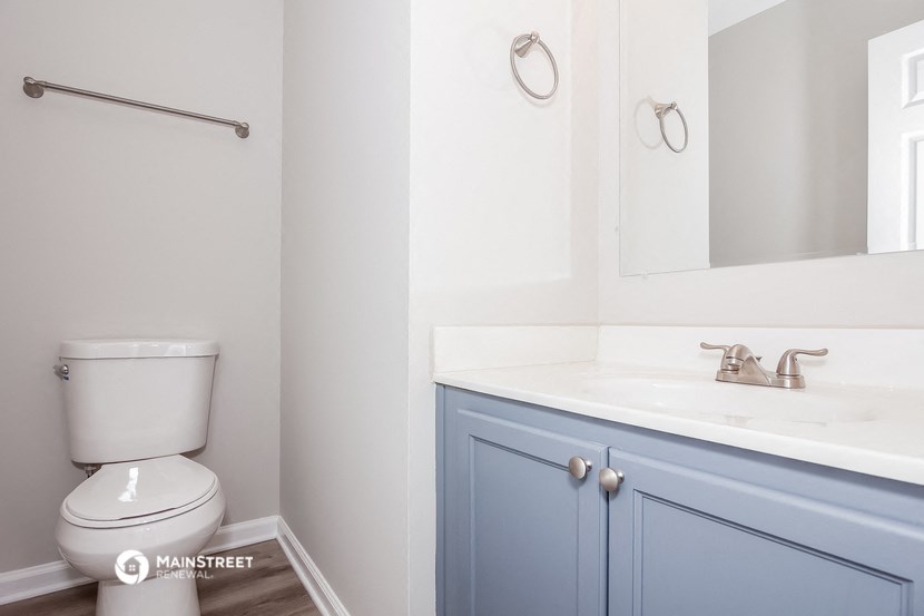 a blue and white bathroom with a toilet and a sink