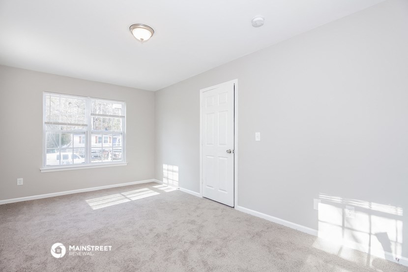 an empty room with a door and a window