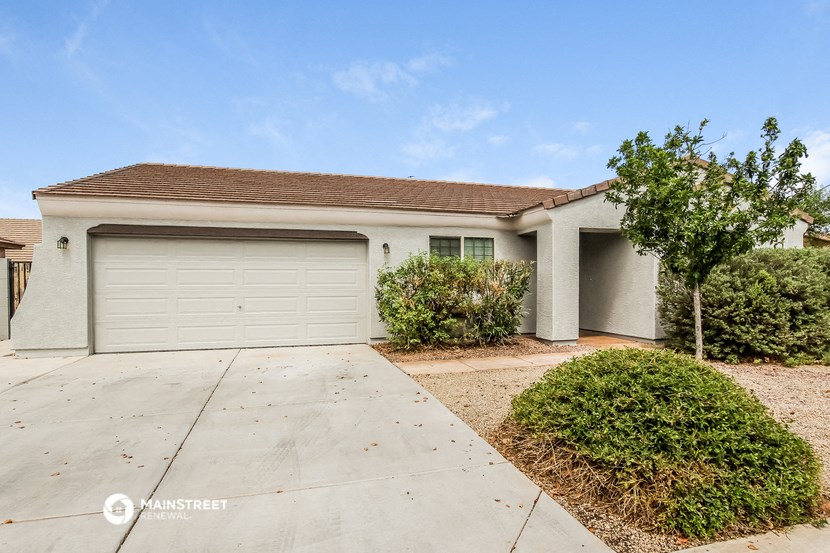 a white house with a driveway and a garage door