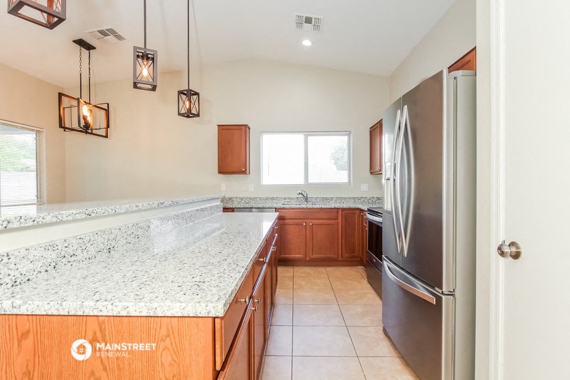 the kitchen has granite counter tops and stainless steel appliances