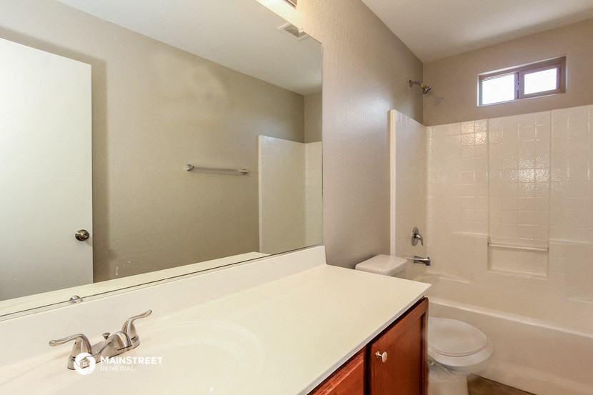 a bathroom with a sink and a shower and a toilet