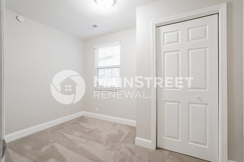 a bedroom with a closet and a white door