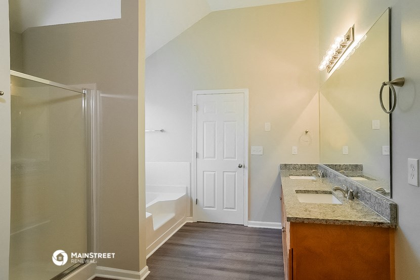 a bathroom with a sink and a mirror and a shower