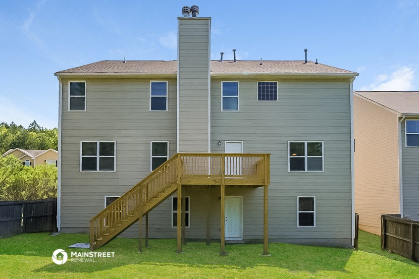 an apartment building with a balcony and a wooden deck