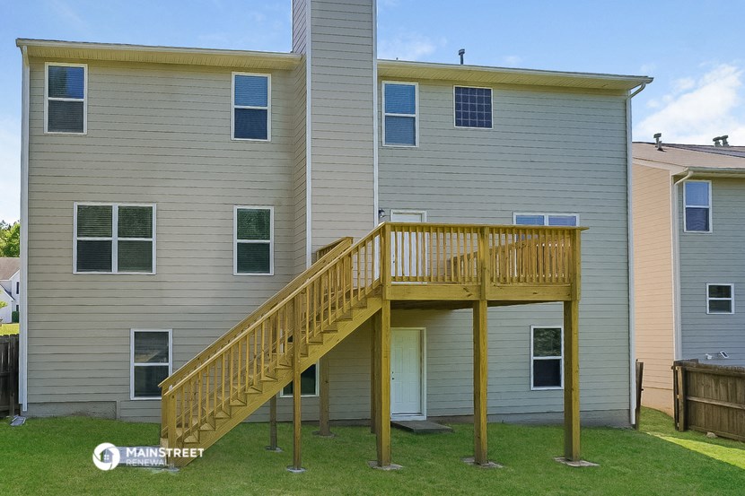 a backyard deck with a wooden staircase