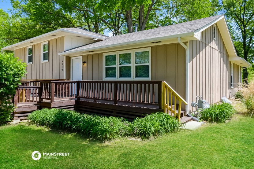 a manufactured home with a porch and a deck