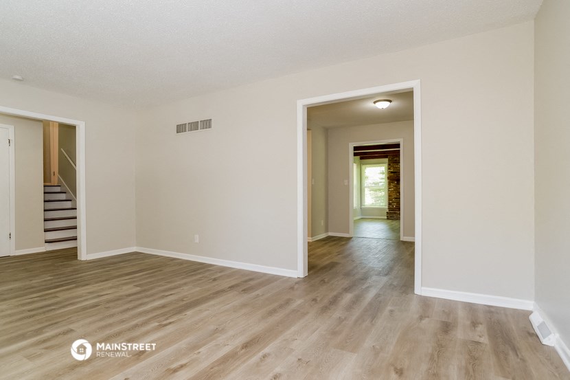 the spacious living room and dining room with hardwood flooring