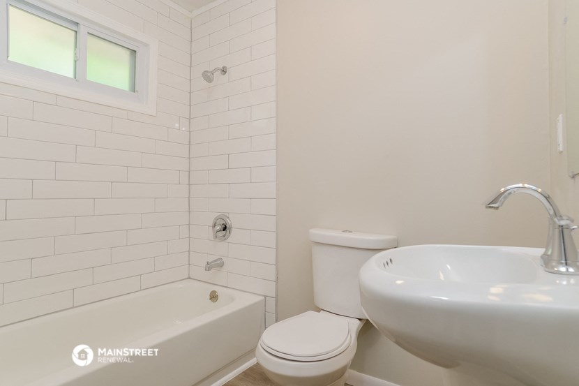 a bathroom with a sink and a toilet and a tub