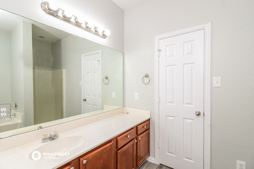 a bathroom with a large mirror and a sink