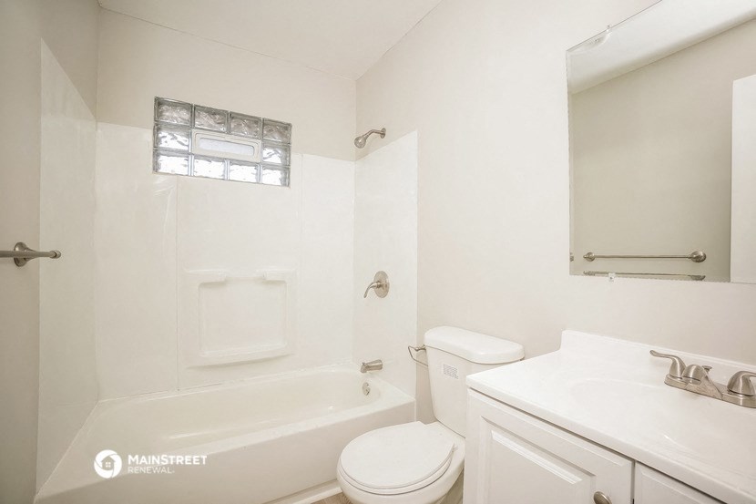 a bathroom with a sink toilet and a bath tub