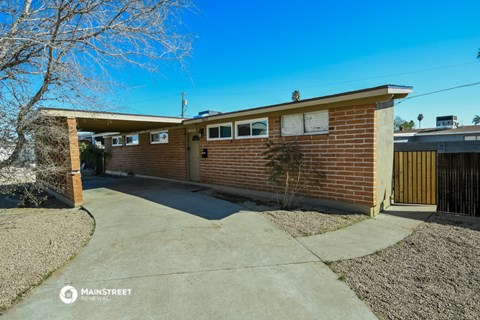 a brick house with a driveway and a garage door
