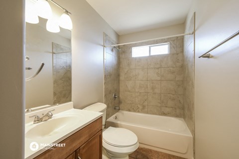 a bathroom with a sink toilet and a shower